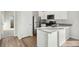 Modern kitchen with stainless steel appliances and an island at 3012 Oxley St, Strasburg, CO 80136