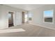 Bright bedroom with carpet flooring and a walk-in closet at 3012 Oxley St, Strasburg, CO 80136