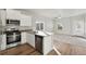 Modern kitchen with stainless steel appliances and light wood flooring at 3012 Oxley St, Strasburg, CO 80136