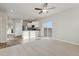 Open living room with wood-look floors and sliding doors at 3012 Oxley St, Strasburg, CO 80136