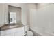 Clean bathroom with a bathtub, toilet and vanity at 3012 Oxley St, Strasburg, CO 80136