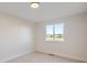 Simple bedroom with large window and neutral decor at 8672 Apache Plume Dr, Parker, CO 80134