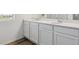 Double sink bathroom vanity with white cabinets and quartz countertop at 4583 Boone Cir, Brighton, CO 80601