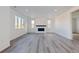 Spacious living room featuring a modern fireplace and vinyl plank flooring at 4583 Boone Cir, Brighton, CO 80601