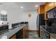 Modern kitchen with black appliances and granite countertops at 34 Highfield Trl # 203, Breckenridge, CO 80424
