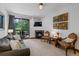 Living room with fireplace and access to outdoor deck at 34 Highfield Trl # 203, Breckenridge, CO 80424