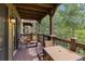 Private deck with table and chairs, offering scenic views of trees and mountains at 34 Highfield Trl # 203, Breckenridge, CO 80424
