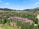 Aerial view of property showing building, landscaping, and mountain views at 34 Highfield Trl # 203, Breckenridge, CO 80424