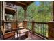 Private deck with outdoor seating, overlooking trees at 34 Highfield Trl # 203, Breckenridge, CO 80424