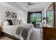 Spacious bedroom with king-size bed and access to a private deck overlooking trees at 34 Highfield Trl # 203, Breckenridge, CO 80424
