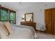 Bright bedroom with king-size bed, dresser, and sliding door to deck at 34 Highfield Trl # 203, Breckenridge, CO 80424