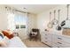 Bedroom with daybed, rocking chair, and a dresser with mirrors at 9912 Cathay St, Commerce City, CO 80022