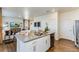 Kitchen with white cabinets, island, and stainless steel appliances at 9912 Cathay St, Commerce City, CO 80022