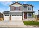 Two-story home with two-car garage and landscaping at 9912 Cathay St, Commerce City, CO 80022