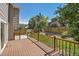 Back deck with wood railings overlooking a fenced backyard at 4037 S Odessa Cir, Aurora, CO 80013