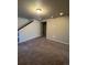 Finished basement featuring neutral walls and carpeting, with staircase access at 5046 Espana Way, Denver, CO 80249