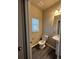 Small bathroom with toilet, sink, and vinyl flooring at 5046 Espana Way, Denver, CO 80249
