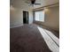 Spacious bedroom with ceiling fan, large window, and en-suite bathroom access at 5046 Espana Way, Denver, CO 80249