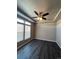 Bright bedroom with dark vinyl flooring and ceiling fan at 5046 Espana Way, Denver, CO 80249