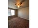 Well-lit bedroom with ceiling fan and large windows for natural light at 5046 Espana Way, Denver, CO 80249