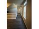 Long hallway with dark hardwood floors and access to upper level at 5046 Espana Way, Denver, CO 80249