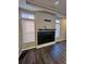 Living room with a fireplace and dark vinyl flooring at 5046 Espana Way, Denver, CO 80249