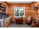 Rustic bar area with wood paneling and built-in cabinetry at 3883 E Fox Trl, Littleton, CO 80121