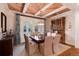 Formal dining room featuring a wood ceiling, a farmhouse table, and a built-in hutch at 3883 E Fox Trl, Littleton, CO 80121