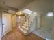 Basement stairs with hardwood floors and white railing at 1453 Chester St, Aurora, CO 80010