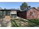 Home with a large backyard, detached garage and paved driveway at 1453 Chester St, Aurora, CO 80010