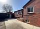 Brick home with a detached garage and paved driveway at 1453 Chester St, Aurora, CO 80010