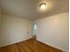 Bedroom with hardwood floors, neutral walls, and access to a bathroom at 1453 Chester St, Aurora, CO 80010
