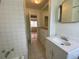 Clean bathroom with tiled walls, vanity, and mirrored medicine cabinet at 1453 Chester St, Aurora, CO 80010