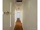 Light-filled hallway with hardwood floors and access to other rooms at 1453 Chester St, Aurora, CO 80010