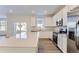 Modern kitchen with white cabinets, stainless steel appliances, and an island at 5515 Wisteria Ave, Firestone, CO 80504