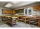 Well-equipped workshop with wooden workbench and storage cabinets at 28730 Mountain View Rd, Conifer, CO 80433