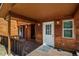 Wooden exterior with deck, white door, and wooden accents at 28730 Mountain View Rd, Conifer, CO 80433