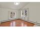 Bright bedroom with wood floors and large windows offering natural light at 28730 Mountain View Rd, Conifer, CO 80433