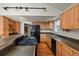 Eat-in kitchen with wood cabinets and black appliances at 28730 Mountain View Rd, Conifer, CO 80433
