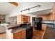 Kitchen with wood cabinets, black appliances, and an island at 28730 Mountain View Rd, Conifer, CO 80433