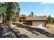 Two-story home with detached garage, nestled in trees at 28730 Mountain View Rd, Conifer, CO 80433