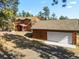 Two-story home with stone accents and detached garage at 28730 Mountain View Rd, Conifer, CO 80433
