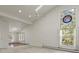 Spacious living room with vaulted ceiling, large window, and carpet flooring at 28730 Mountain View Rd, Conifer, CO 80433