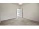 Simple bedroom with carpet flooring and access to another room at 28730 Mountain View Rd, Conifer, CO 80433