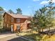 Two-story home with wood siding and a gravel driveway at 28730 Mountain View Rd, Conifer, CO 80433