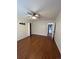 Bedroom with laminate wood floor, ceiling fan, and access to laundry at 4361 Argonne St, Denver, CO 80249