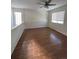 Bedroom with laminate flooring, ceiling fan, and window at 4361 Argonne St, Denver, CO 80249