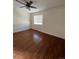 Bedroom with laminate flooring, window, and ceiling fan at 4361 Argonne St, Denver, CO 80249