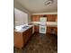 Galley kitchen with wood cabinets and tiled floor at 4361 Argonne St, Denver, CO 80249