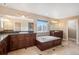 Luxurious bathroom with double vanity and large soaking tub at 8445 S Estes St, Littleton, CO 80128